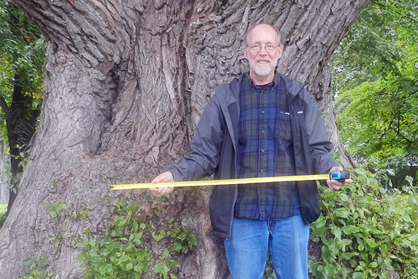 Dr. Richard Birdsey stands next to a large tree.