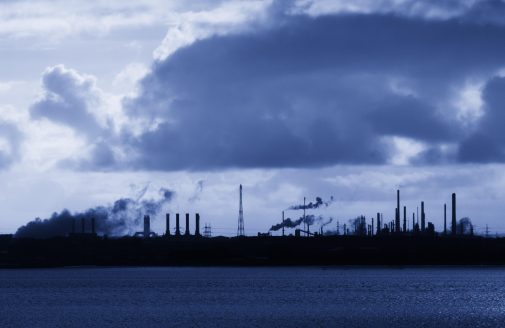 Silhouetted industrial area with smokestacks