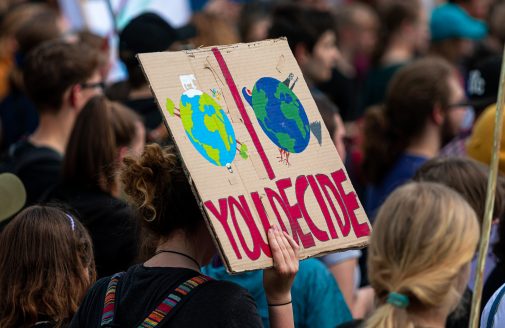 Climate activism demonstration sign reading "you decide."