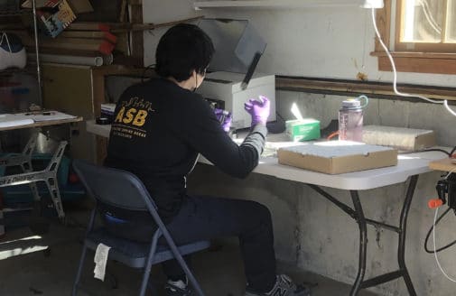 Gabe Duran working in his makeshift garage lab.