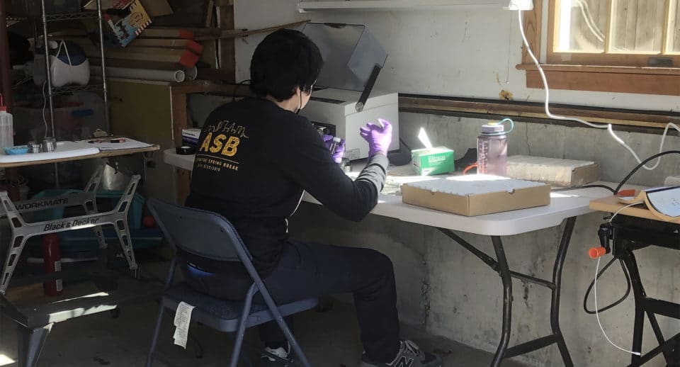 Gabe Duran working in his makeshift garage lab.