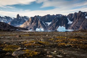 Arctic mountains and lake with melting ice