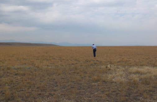 man standing on ranch near Bozeman Montana, photo by Jonathan Sanderman