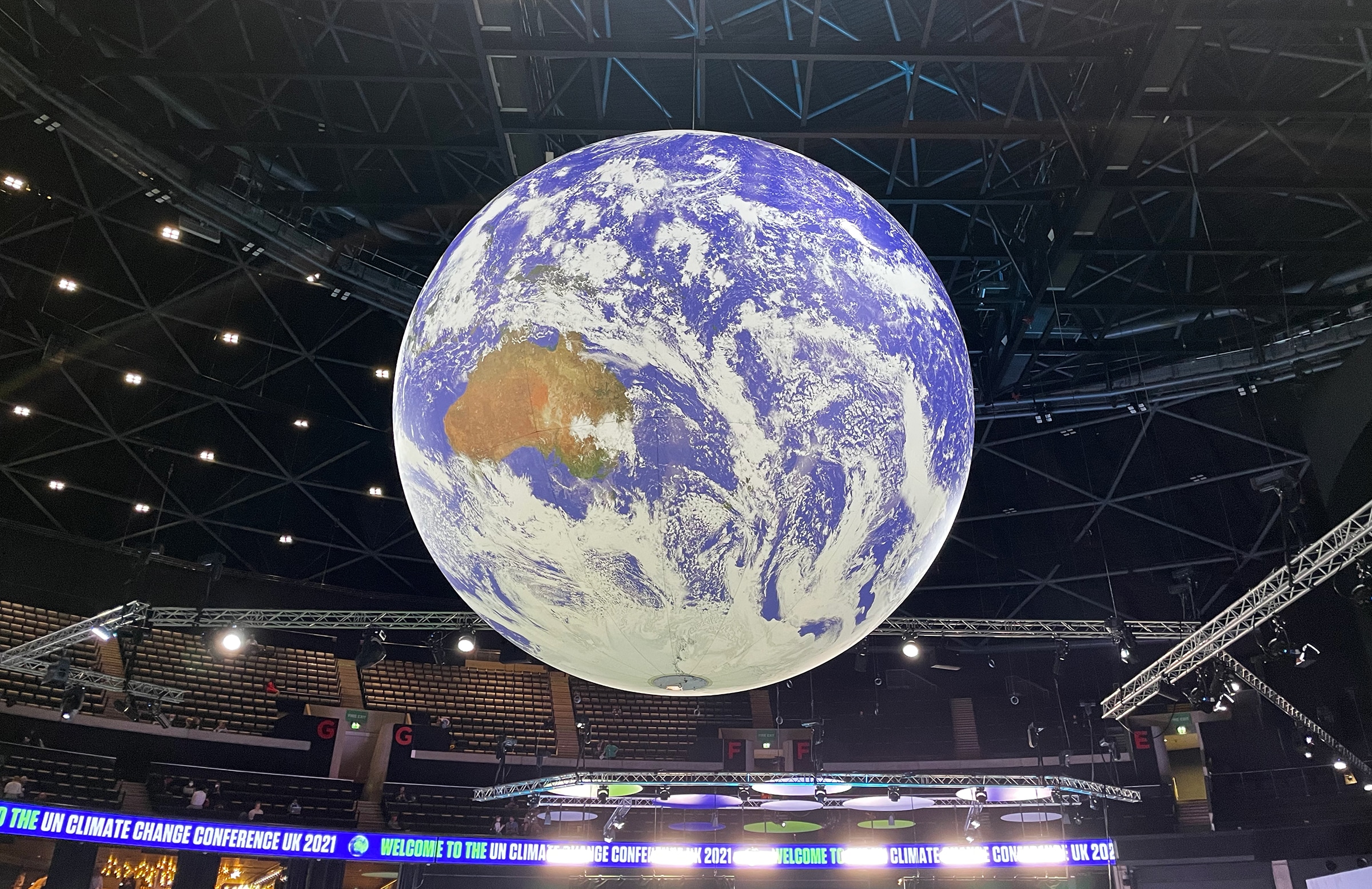 hanging globe above the main stage at COP26, photo by Beth Brazil