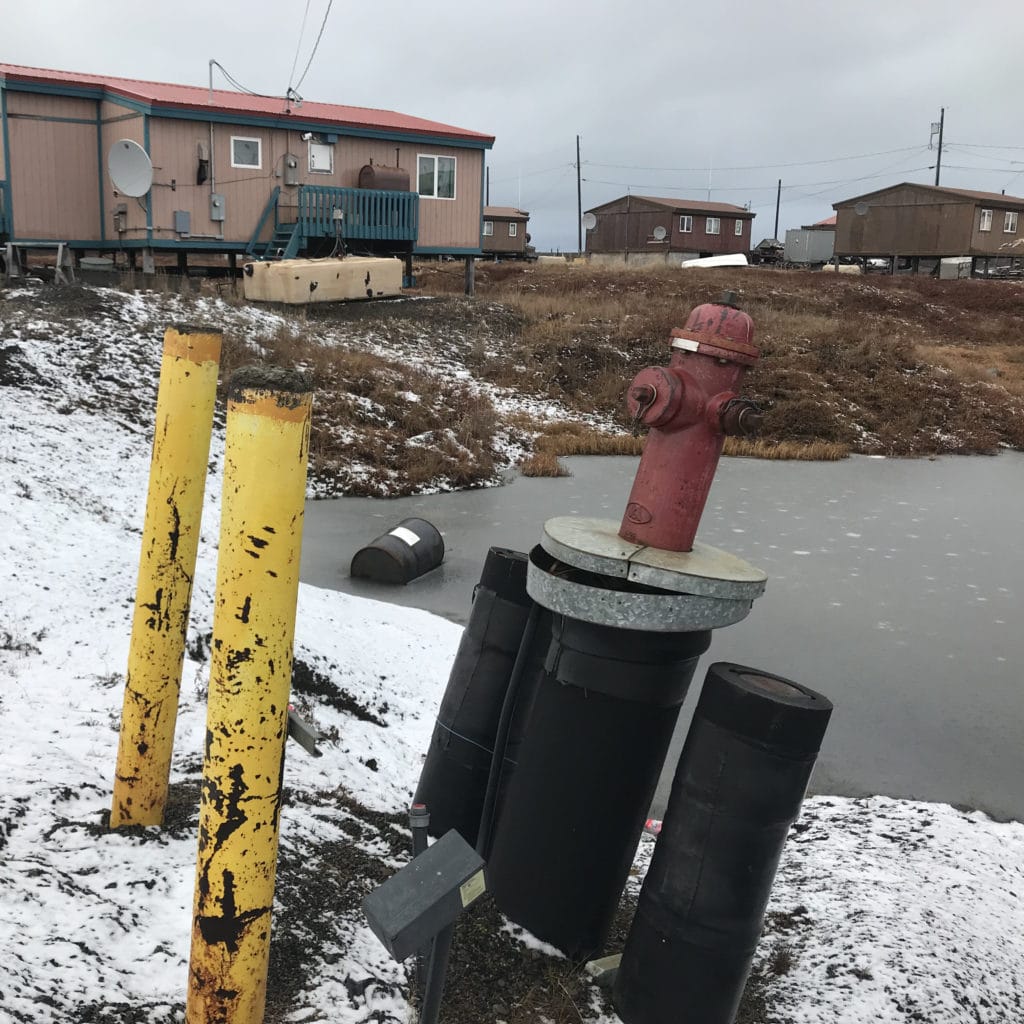 Leaning fire hydrant from subsiding ground illustrating hazards of permafrost thaw