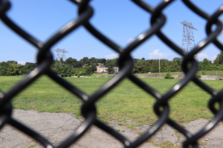 power lines in field behind fence