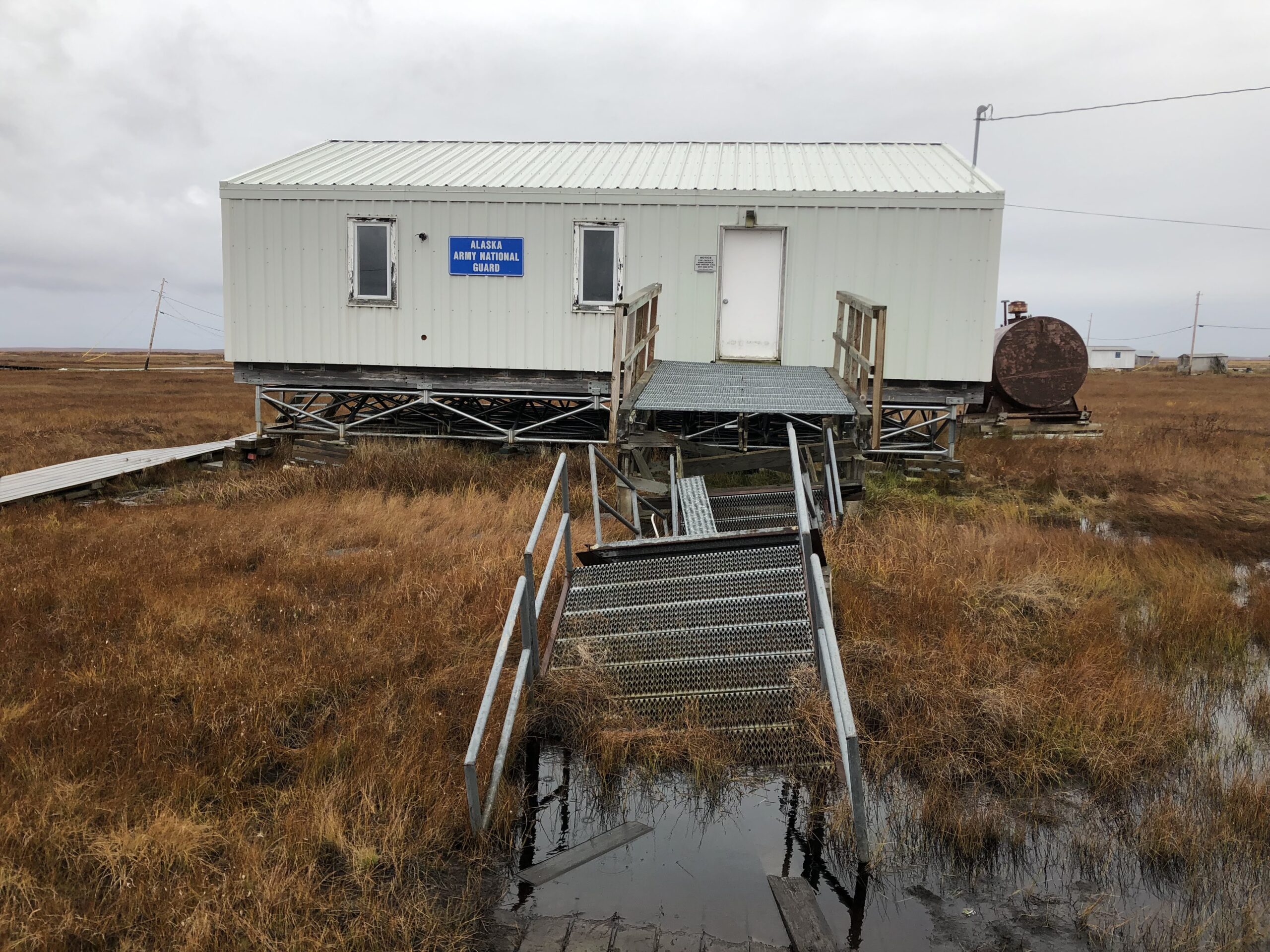 Land subsidence caused by permafrost thaw in an Alaska Native village.