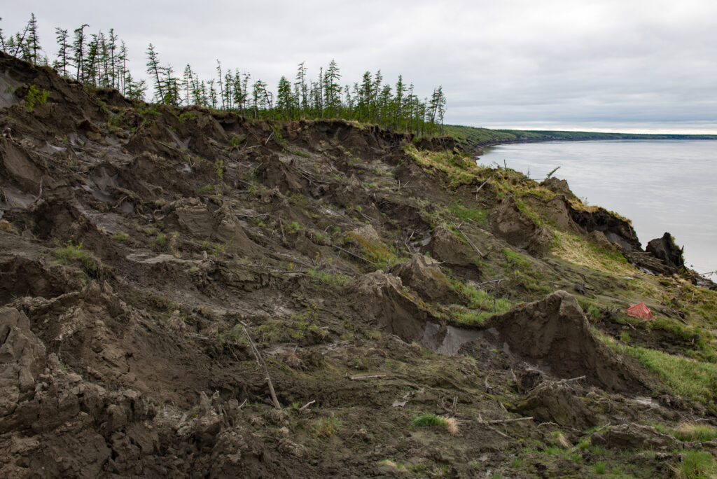 collapsing slope near water in siberia due to permafrost thaw