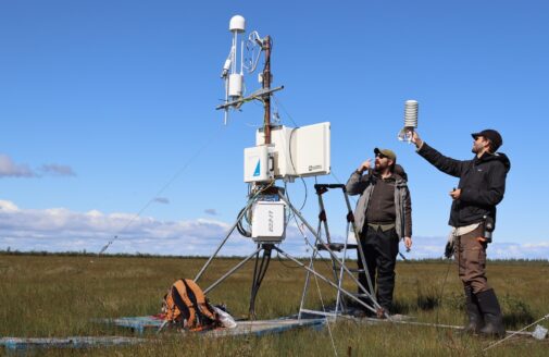 Two researchers installing an eddy covariance flux tower