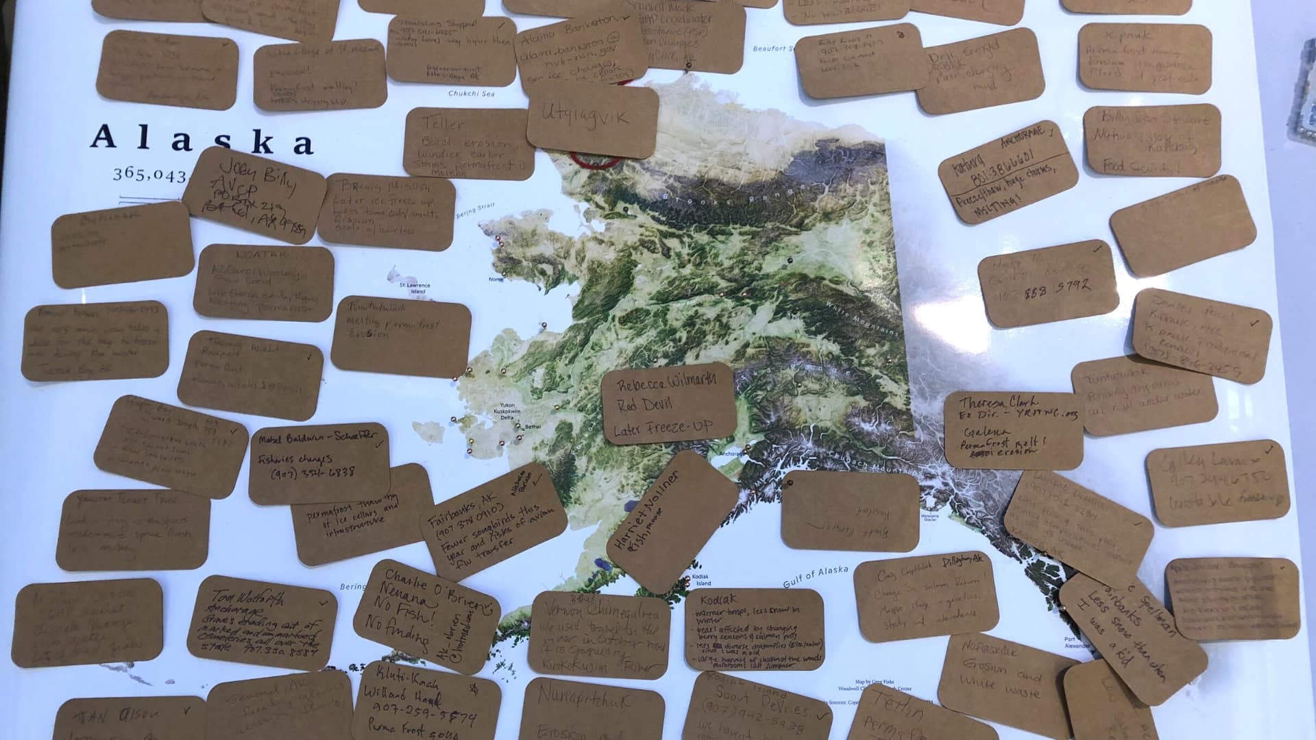 map of Alaska covered in small notes on brown cards