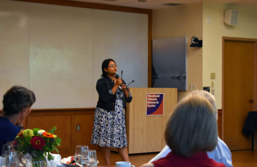 Taniya RoyChowdhury presents in front of a Woodwell Podium