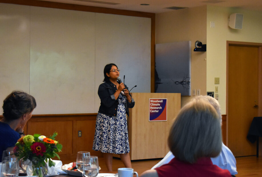 Taniya RoyChowdhury presents in front of a Woodwell Podium