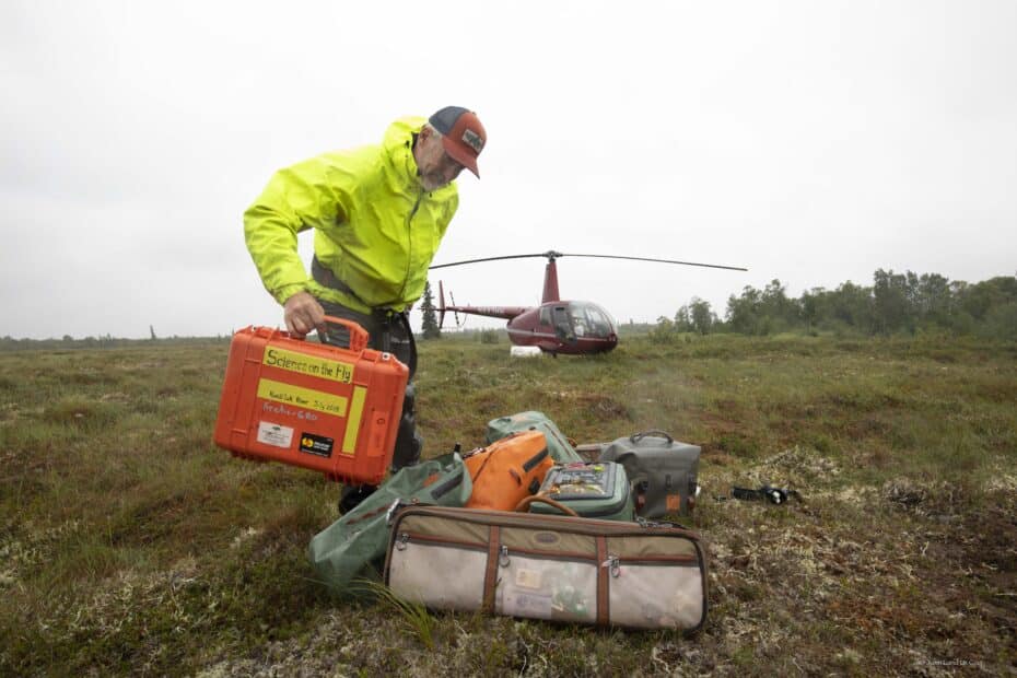 Dr. R. Max Holmes adds an orange tote labeled 