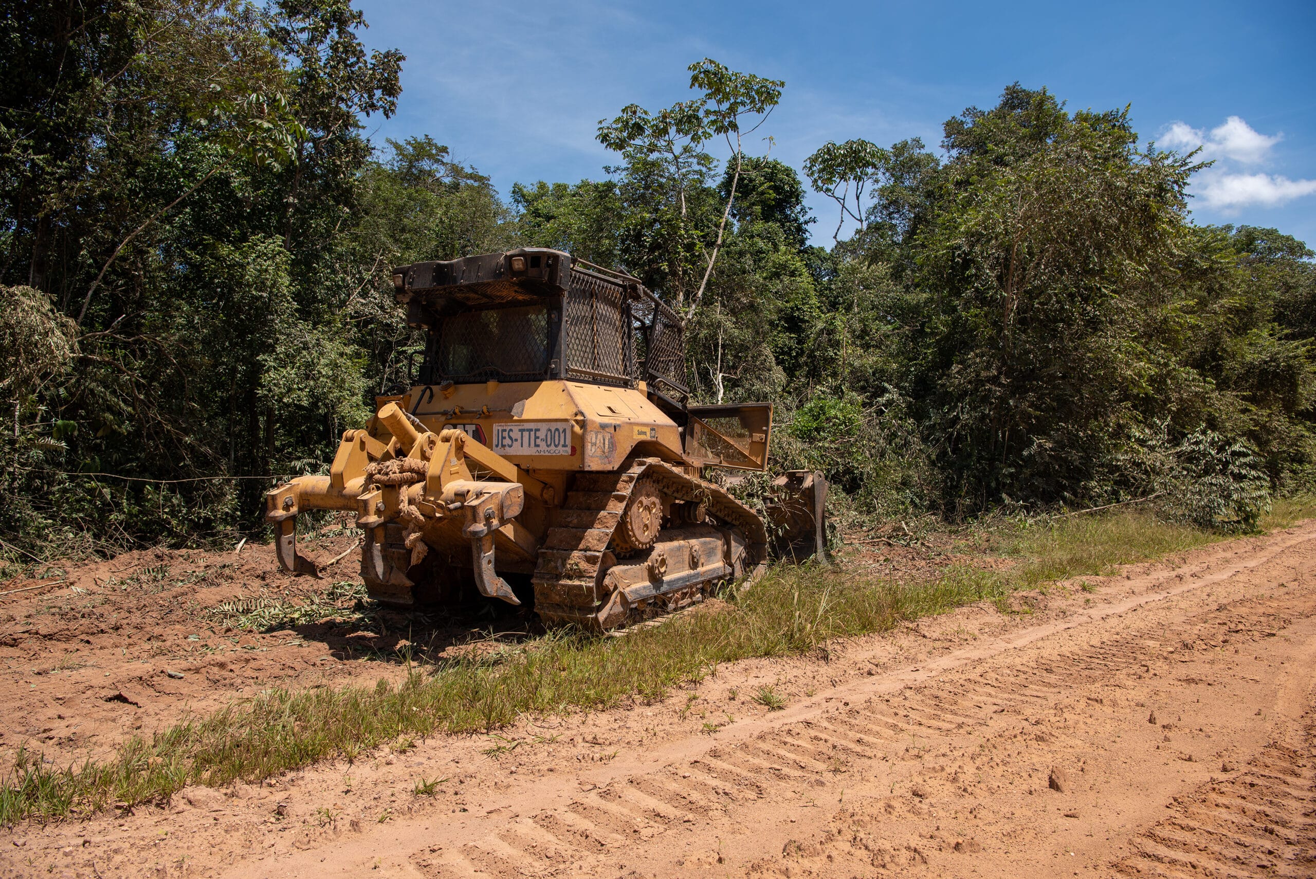 bulldozer standing on the edge of the forest after clearing a road