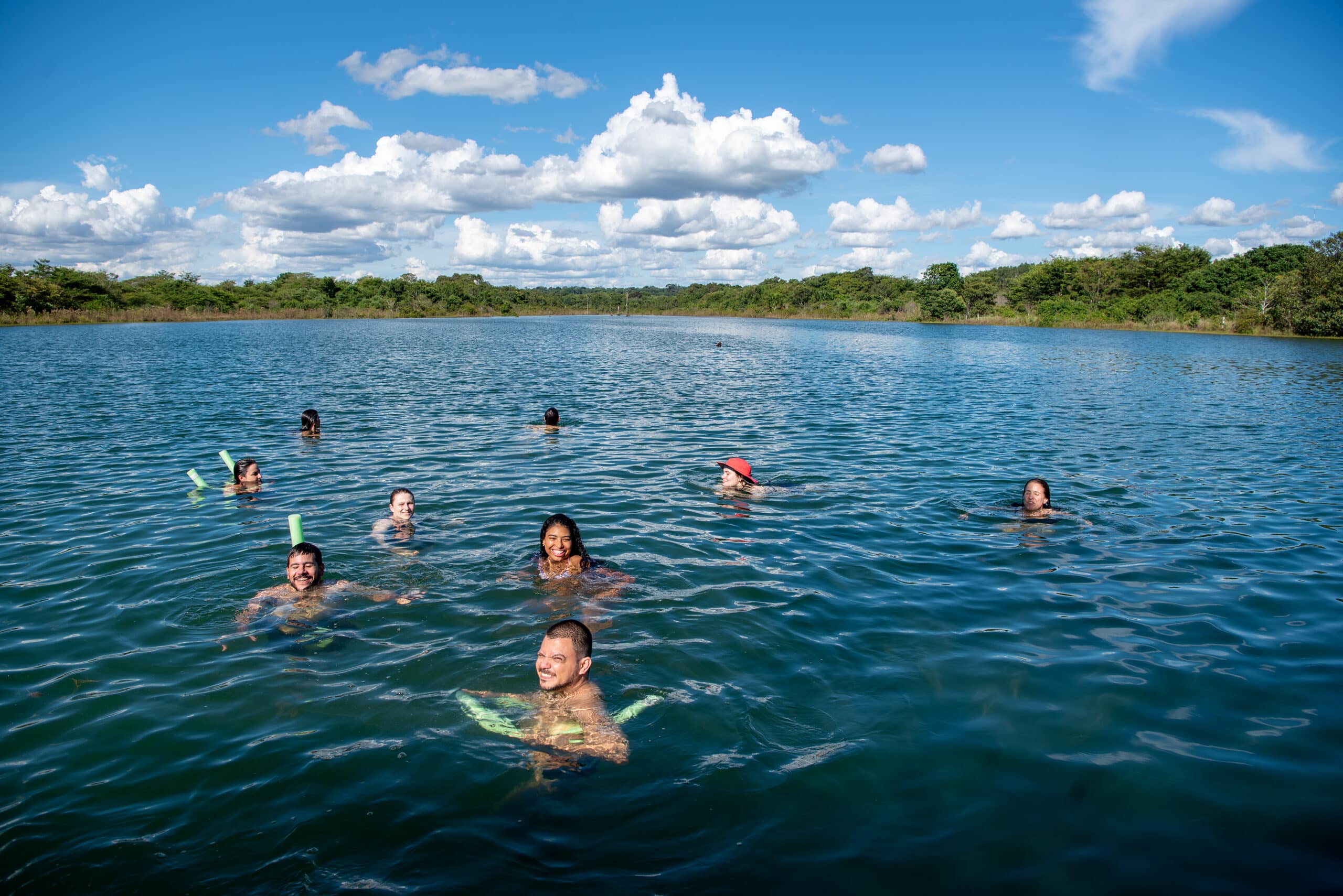 swimmers floating in the blue reservoir of darro