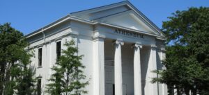 A photo of the Nantucket Atheneum, a white building with tall columns at the front