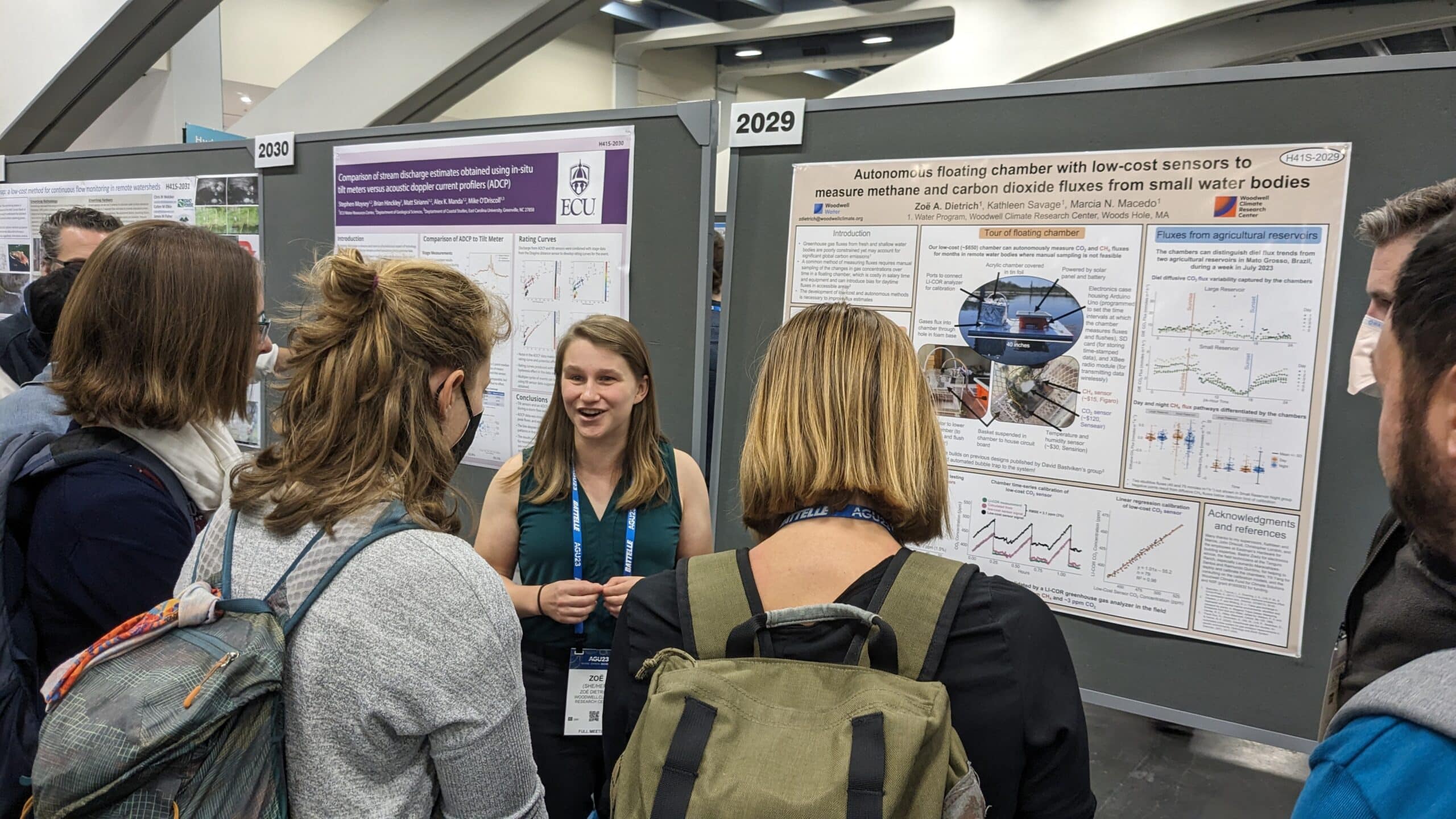 dietrich presents to a crowd at AGU standing in front of a poster of her work