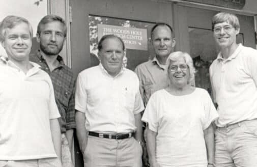 black and white photo of a group of 6 people, 5 men and 1 woman. George Woodwell is pictured at center