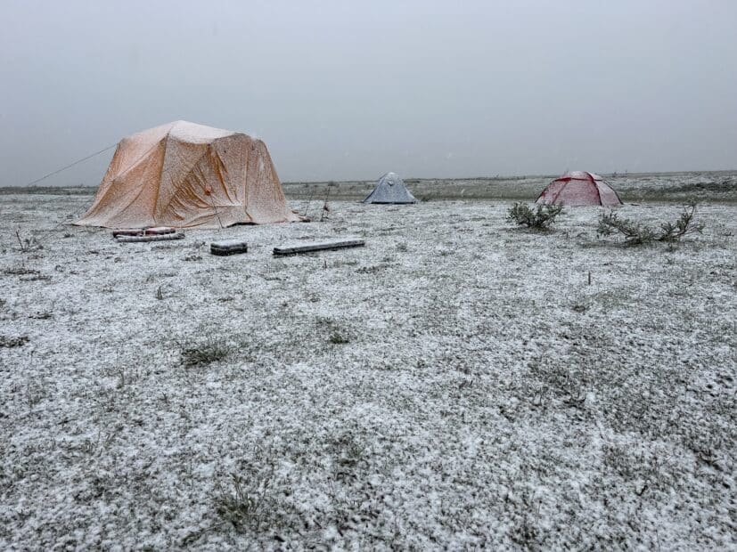 snowy tundra with yellow tent