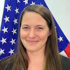 photo of Amanda McCarty in front of a US flag